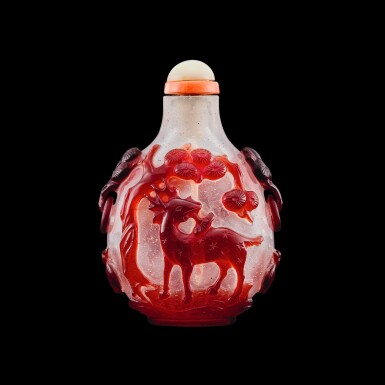 View full screen - View 1 of Lot 1050. A ruby-red overlay glass 'longevity' snuff bottle, Qing dynasty, 18th century | 清十八世紀 珍珠地套寶石紅料松鶴延年活環耳鼻煙壺.