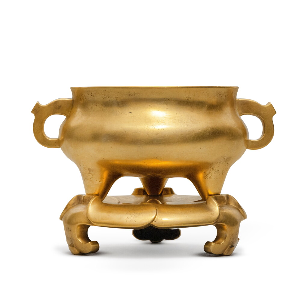 View full screen - View 1 of Lot 1304. A gilt-bronze tripod censer and stand | 銅鎏金壓經爐連座.