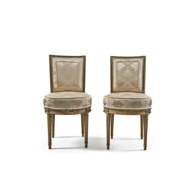 View full screen - View 1 of Lot 339. A Pair of Louis XVI Grey-Painted Beechwood Chaises en Cabriolet, by Georges Jacob, Circa 1780.