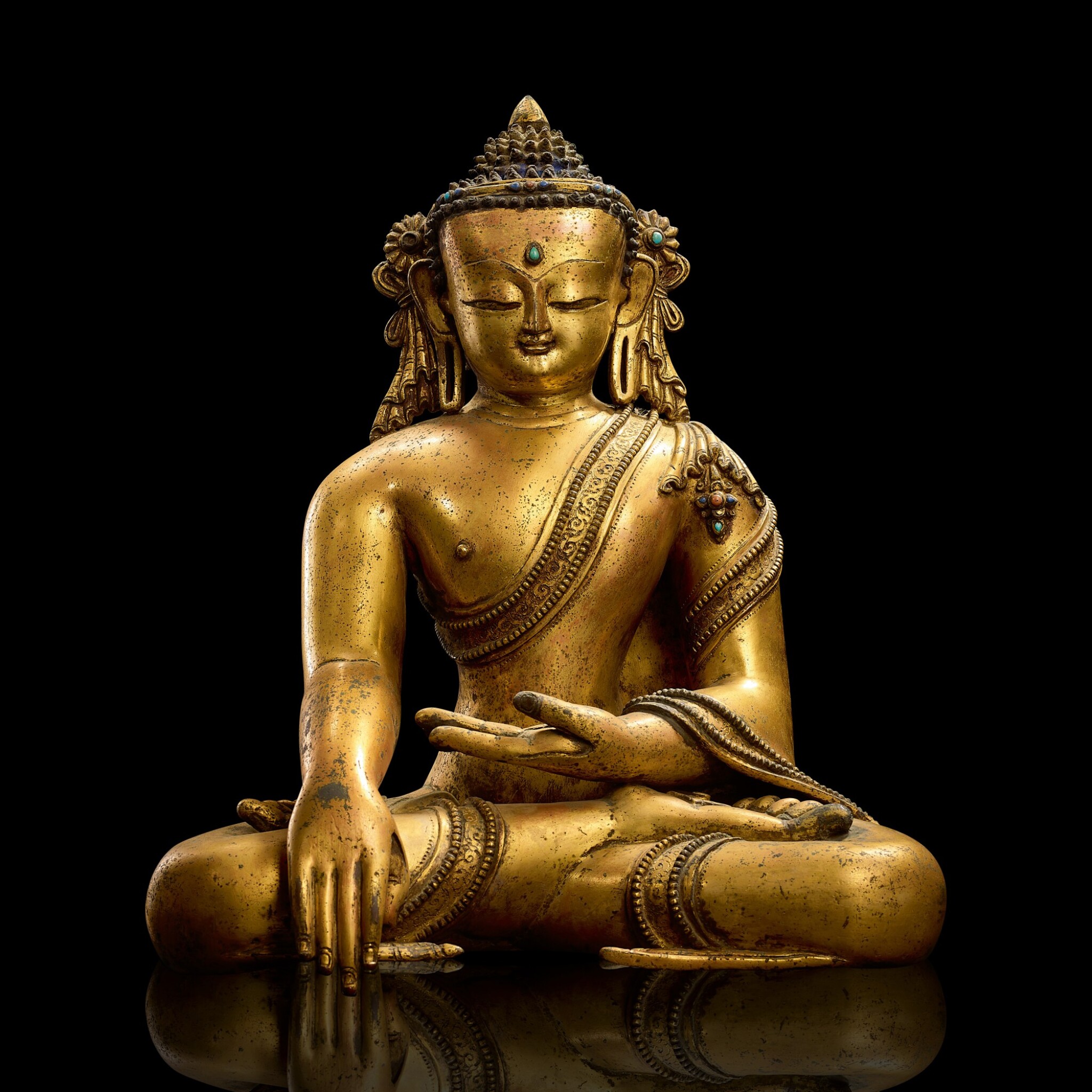 A Magnificent Gilt Copper Alloy Figure Of Shakyamuni Buddha Nepal Or Tibet 13th 14th Century 十三至十四世紀尼泊爾或西藏鎏金銅釋迦牟尼佛坐像 A A Magnificent Gilt Copper Alloy Figure Of Shakyamuni Buddha Nepal Or Tibet 13th 14th Century 十三至十四世紀尼泊爾或西藏鎏金銅釋迦牟尼佛坐像 A