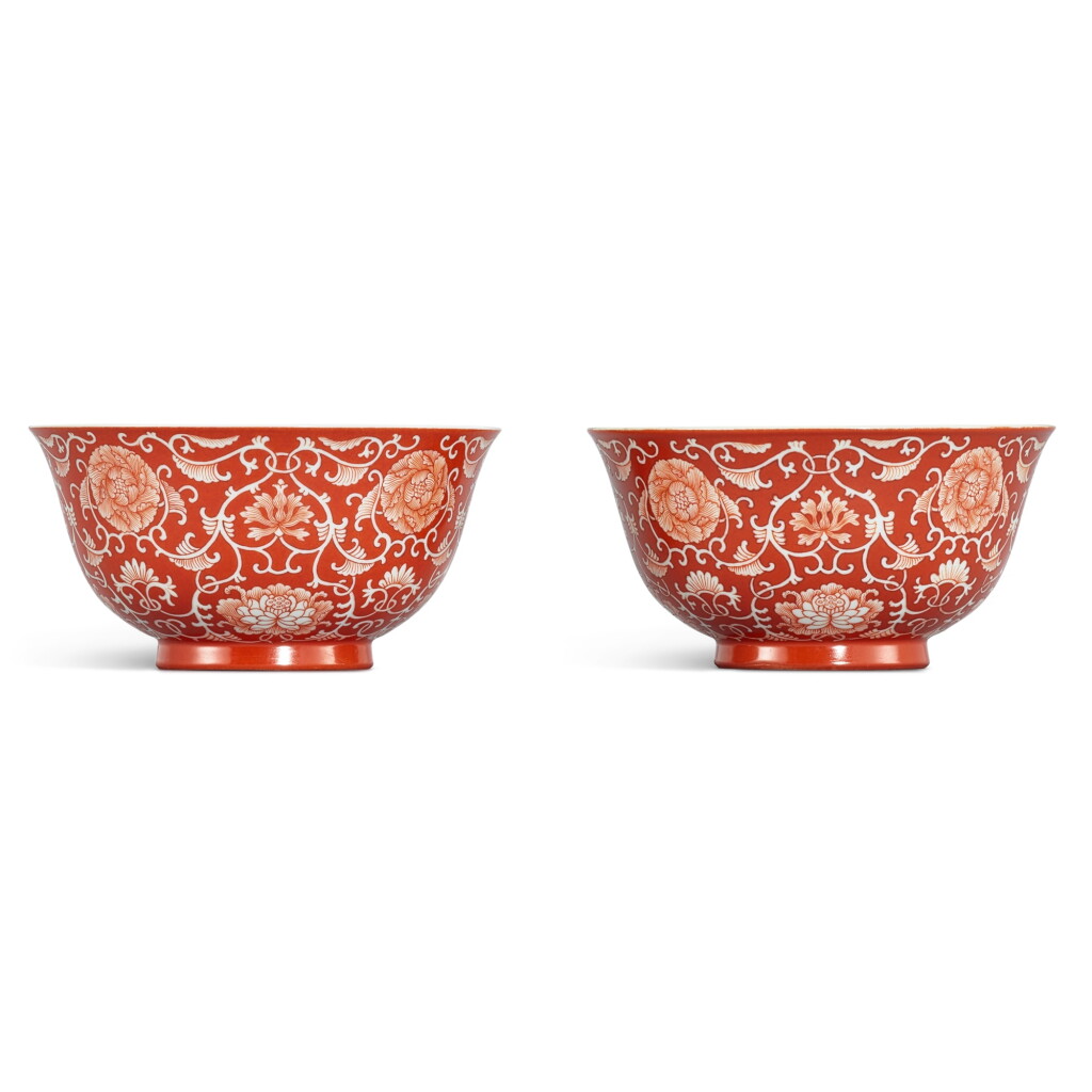 View full screen - View 1 of Lot 305. A fine pair of coral-red reverse-decorated 'lotus' bowls, Seal marks and period of Qianlong 清乾隆 珊瑚紅地留白纏枝蓮花紋盌一對 《大清乾隆年製》款.