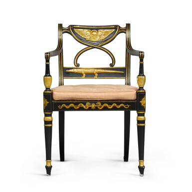 View full screen - View 1 of Lot 23. A late George III ebonised and parcel-gilt armchair, in the Egyptian Revival style, circa 1805.