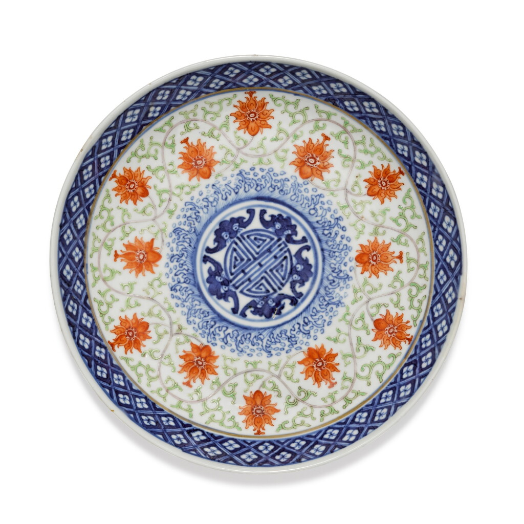 View full screen - View 1 of Lot 143. An iron-red and blue and white ‘bat and lotus’ dish Mark and period of Guangxu | 清光緒 青花礬紅彩五福捧壽紋盤 《大清光緒年製》款.