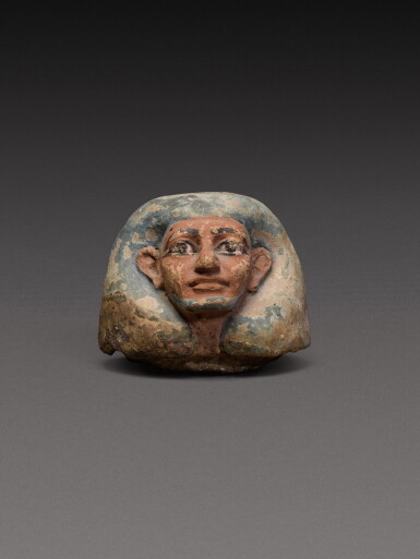 View full screen - View 1 of Lot 118. An Egyptian Polychrome Terracotta Canopic Jar Lid, 18th Dynasty, 1540-1292 B.C..