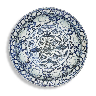 View full screen - View 1 of Lot 8. A rare large blue and white moulded 'mandarin duck and lotus pond' dish, Yuan dynasty | 元 青花荷塘鴛鴦紋花口大盤.