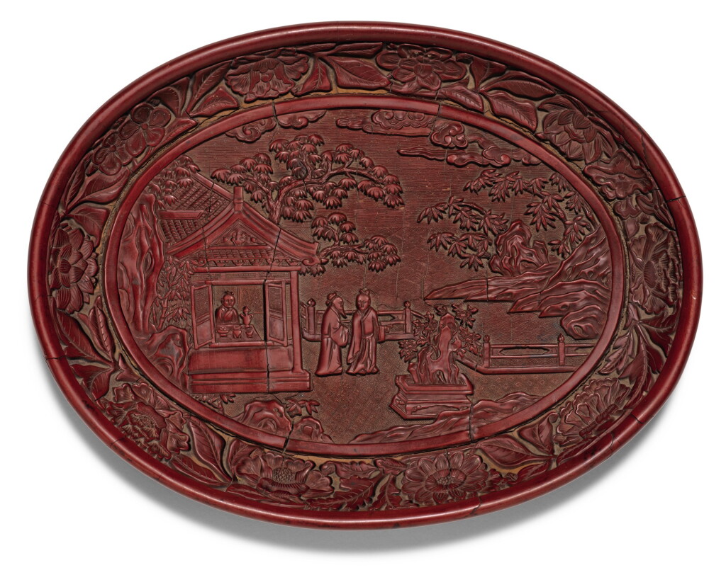 View full screen - View 1 of Lot 139. A RARE AND FINELY CARVED CINNABAR LACQUER DISH YONGLE MARK AND PERIOD | 明永樂 剔紅賞石圖橢圓盤 《大明永樂年製》款.