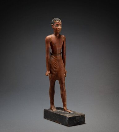 View full screen - View 1 of Lot 214. An Egyptian Wood Figure of a Man, Old Kingdom, 6th Dynasty, 2360-2195 B.C..