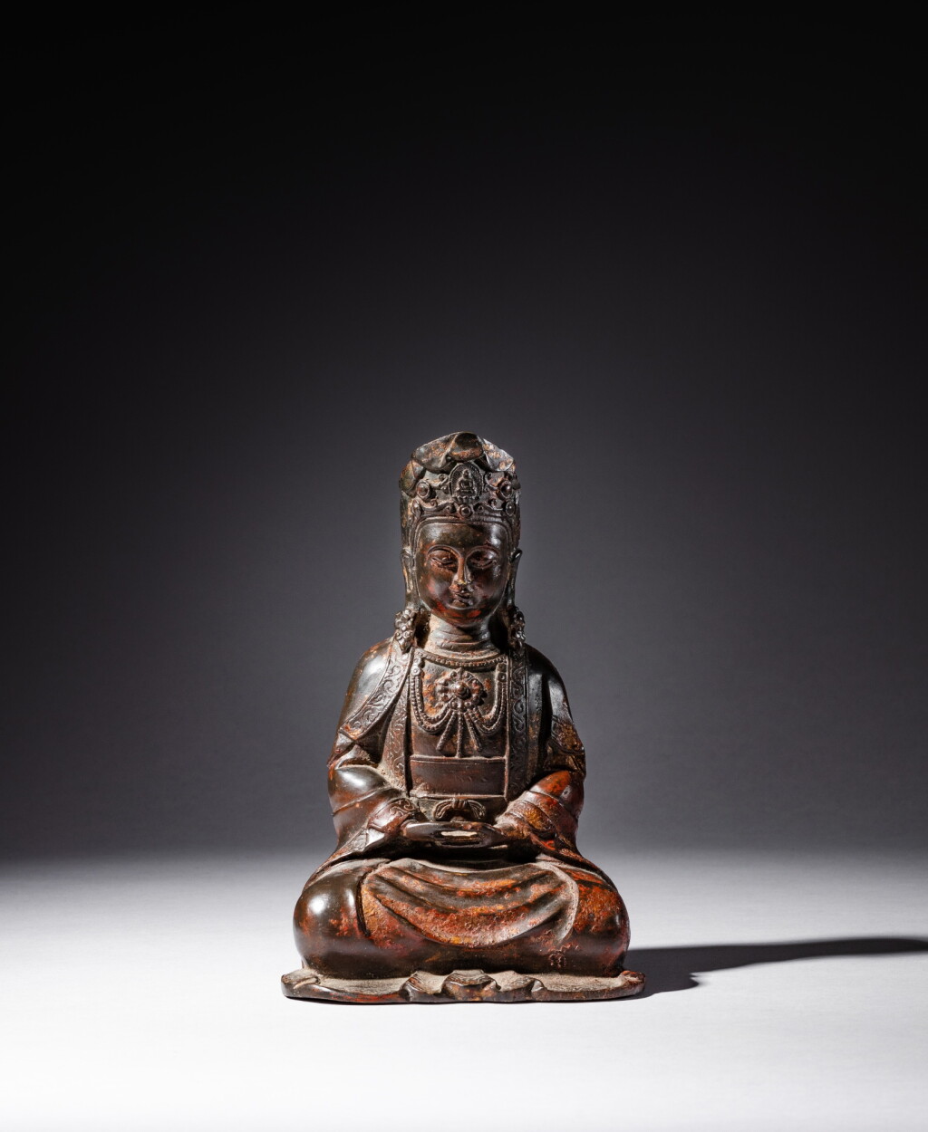 View full screen - View 1 of Lot 60. A lacquer-gilt bronze figure of Avalokiteshvara, Late Ming - early Qing dynasty, 17th century | 明末至清初十七世紀 漆金銅觀音菩薩坐像.