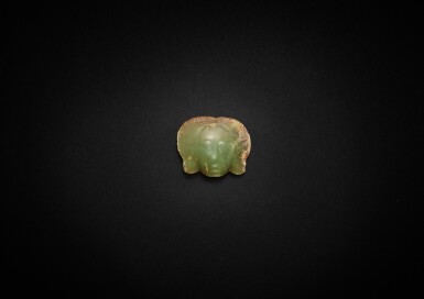 View full screen - View 1 of Lot 3777. A yellowish-celadon and russet jade 'human face' ornament, Inner Mongolia, Neolithic period, 3rd millennium BC | 新石器時代 公元前三千年 內蒙古青黃玉人面飾.