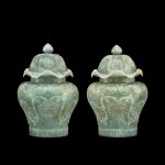 A pair of jadeite 'lotus' jars and covers | 翠玉雕番蓮如意肩蓋罐一對