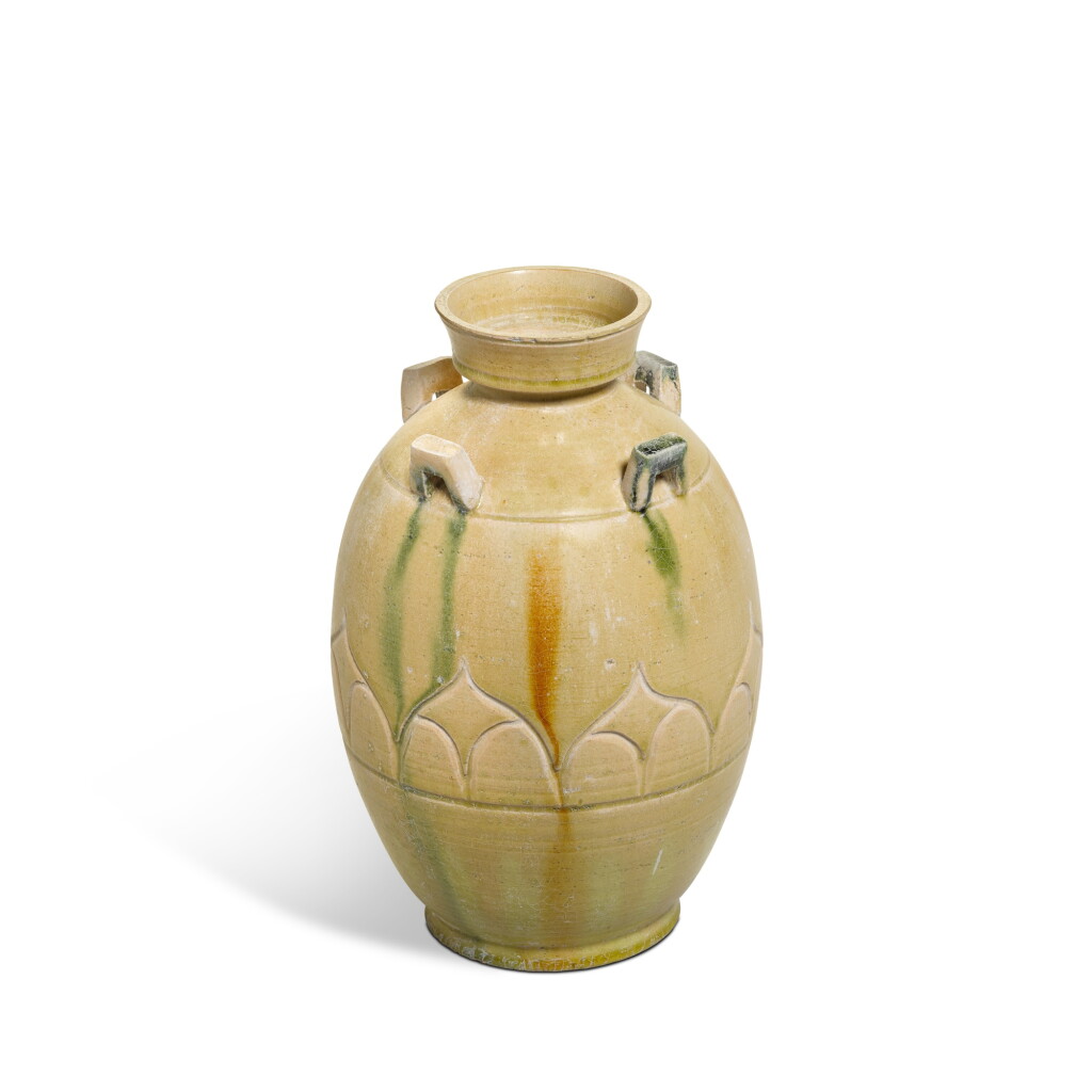 View full screen - View 1 of Lot 879. A green-splashed straw-glazed 'lotus' jar, Northern Qi dynasty.