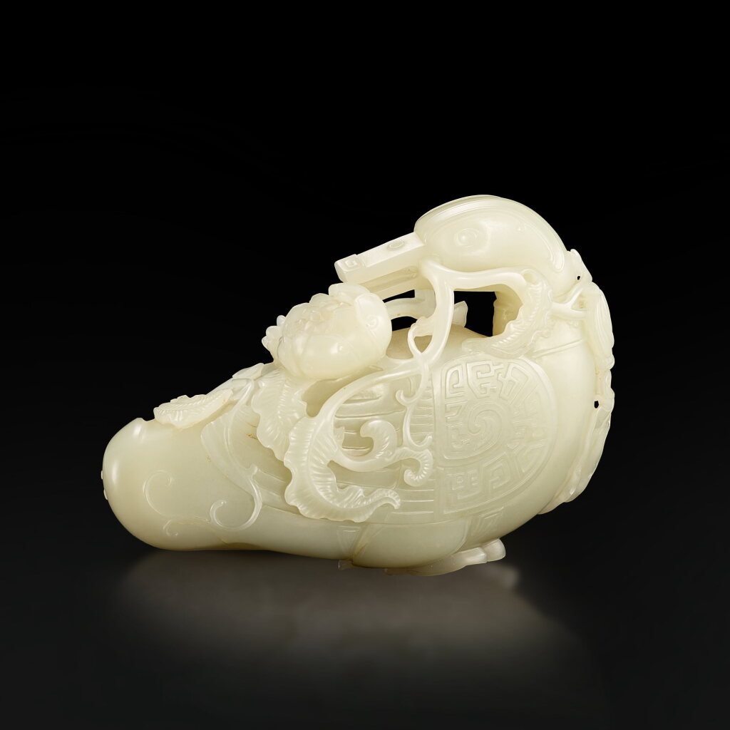 View full screen - View 1 of Lot 3680. A white jade archaistic 'duck and lotus' group, Qing dynasty, 18th century | 清十八世紀 白玉仿古銜蓮寶鴨.