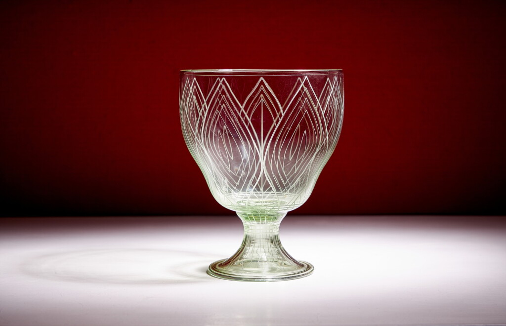 View full screen - View 1 of Lot 34. An engraved glass vase by Harry J. Powell, circa 1910, James Powell & Sons (Whitefriars Glass).