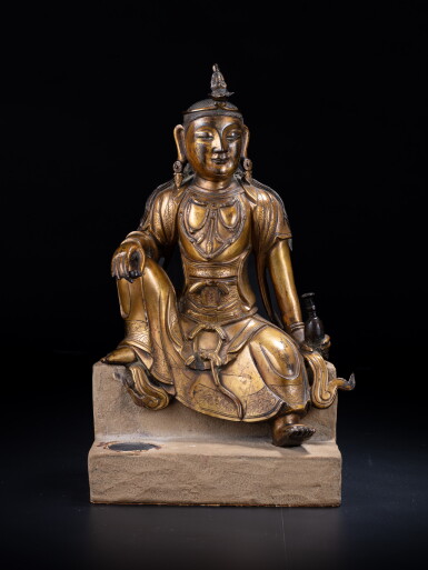 View full screen - View 1 of Lot 20. A gilt-bronze seated figure of Avalokiteshvara, Ming dynasty, 15th / 16th century.