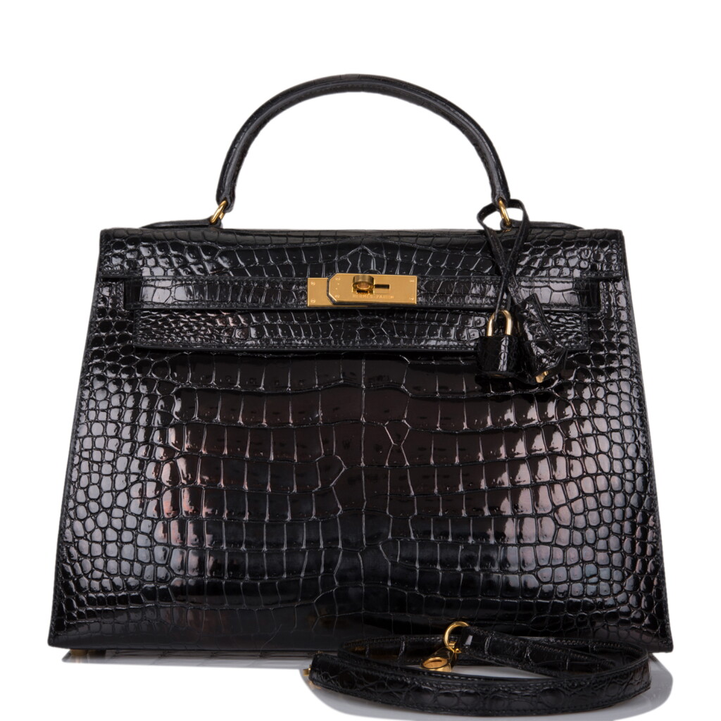 View full screen - View 1 of Lot 18. HERMÈS | BLACK SELLIER KELLY 32CM IN SHINY POROSUS CROCODILE WITH GOLD HARDWARE.