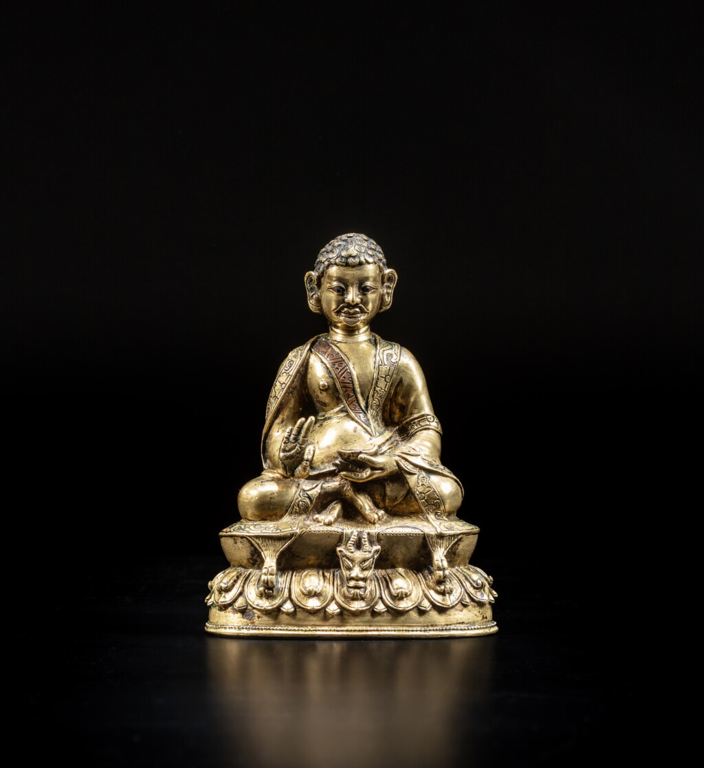 View full screen - View 1 of Lot 9. A silver and copper-inlaid copper alloy figure of Padampa Sanggye, Tibet, 15th / 16th century | 十五 / 十六世紀 藏傳銅合金錯銀銅當巴桑傑大師坐像.