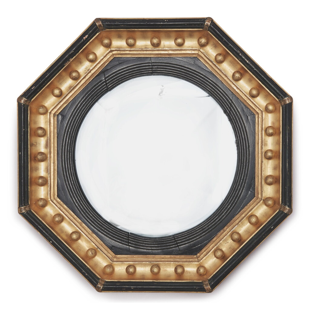 View full screen - View 1 of Lot 33. A REGENCY OCTAGONAL PARCEL-GILT AND EBONIZED WOOD CONVEX MIRROR, 19TH CENTURY.