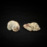 A pale celadon and russet jade carved elephant and a 'lion and cub' group, Late Ming to early Qing dynasty 明末清初 青玉象形墜飾及太獅少獅墜飾