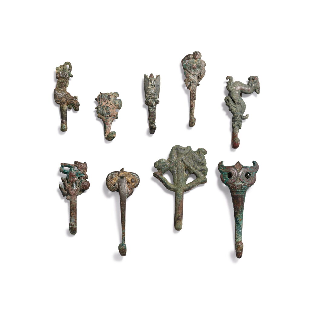 View full screen - View 1 of Lot 740. Nine bronze 'figure and animal' belt hooks, Eastern Zhou dynasty, Warring States period - Western Han dynasty | 東周戰國至西漢 青銅動物人物帶鉤 一組九件.