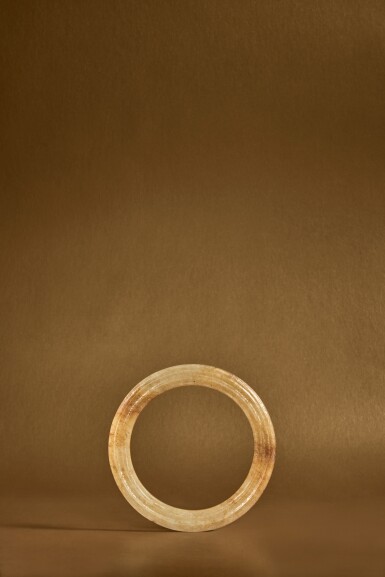 View full screen - View 1 of Lot 110. A carved yellow jade fluted ring (Huan), Eastern Zhou dynasty, Warring States period .