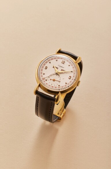 View full screen - View 1 of Lot 21. Triple Date Calendar | A yellow gold triple calendar wristwatch with two-tone dial, tear drop lugs and gold deployant buckle, Circa 1946.