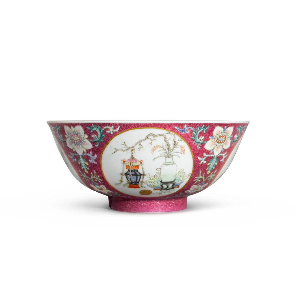 View full screen - View 1 of Lot 131. A fine ruby-ground sgraffiato ‘hundred antiques’ bowl, Seal mark and period of Daoguang | 清道光 胭脂紅地軋道粉彩開光博古圖盌 《大清道光年製》款.