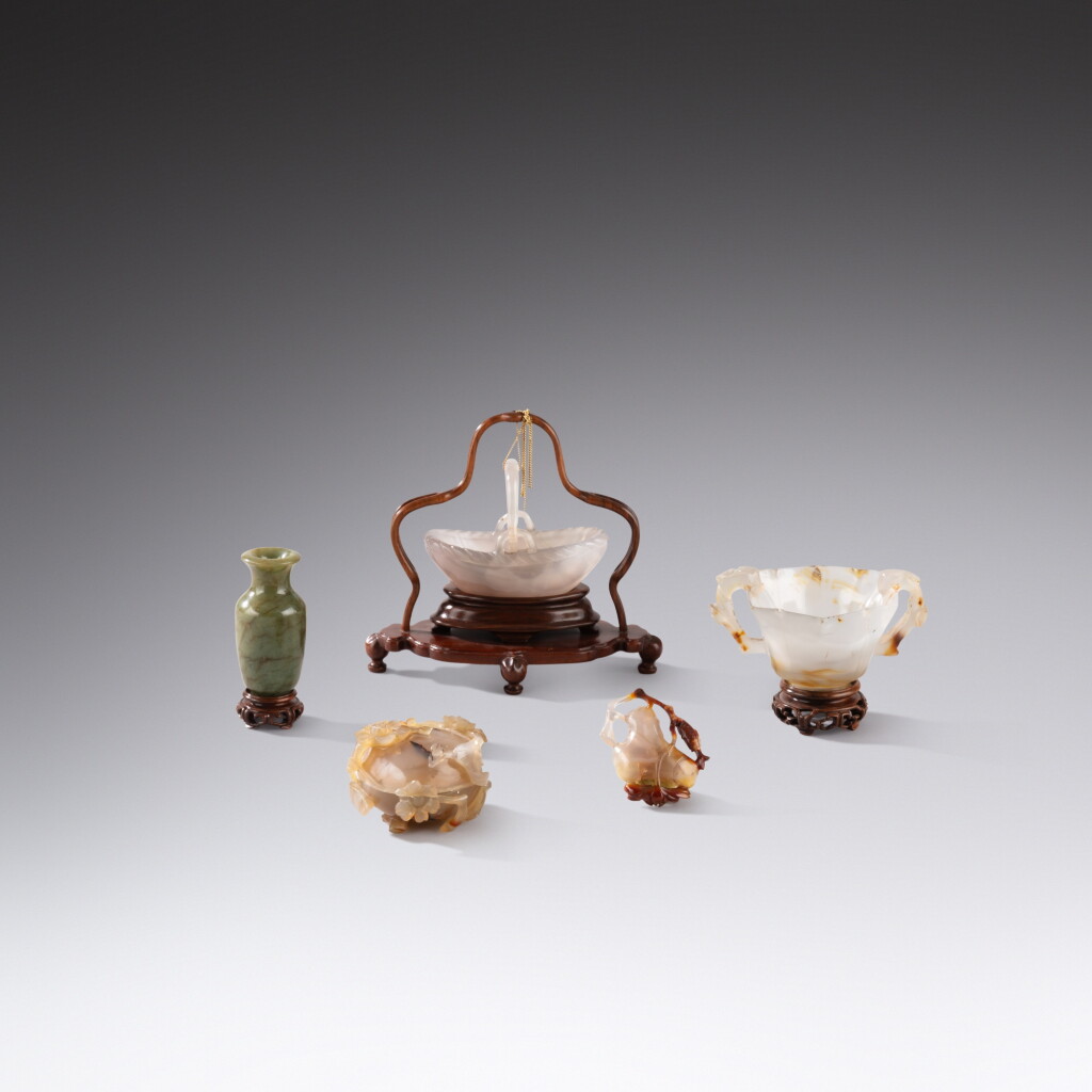 View full screen - View 1 of Lot 45. A group of four carved agate implements and a spinach-green jade miniature vase, Qing dynasty | 清 瑪瑙雕文房器 及 碧玉雕小瓶 一組五件.