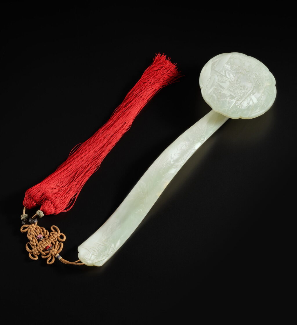 View full screen - View 1 of Lot 296. A pale celadon jade 'immortals' ruyi scepter, Qing dynasty, 19th century | 清十九世紀 青白玉雕仙人圖如意.