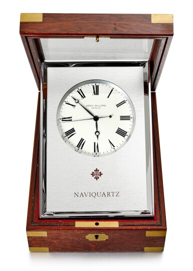 View full screen - View 1 of Lot 193. PATEK PHILIPPE | REFERENCE E1200, AN ALUMINUM TABLE CLOCK WITH FITTED WOODEN CASE, CIRCA 1970.