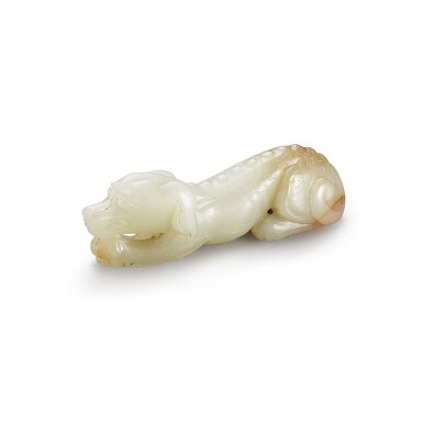 View full screen - View 1 of Lot 134. A celadon jade figure of a dog, Ming dynasty | 明 青玉臥犬.