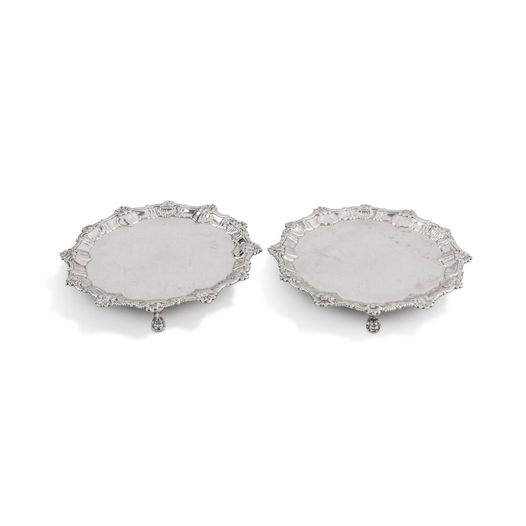 View full screen - View 1 of Lot 824. Two George II silver matching pair of waiters, one by Ebenezer Coker and Thomas Hanam, one by Ebenezer Coker, London, 1759 and 1760.
