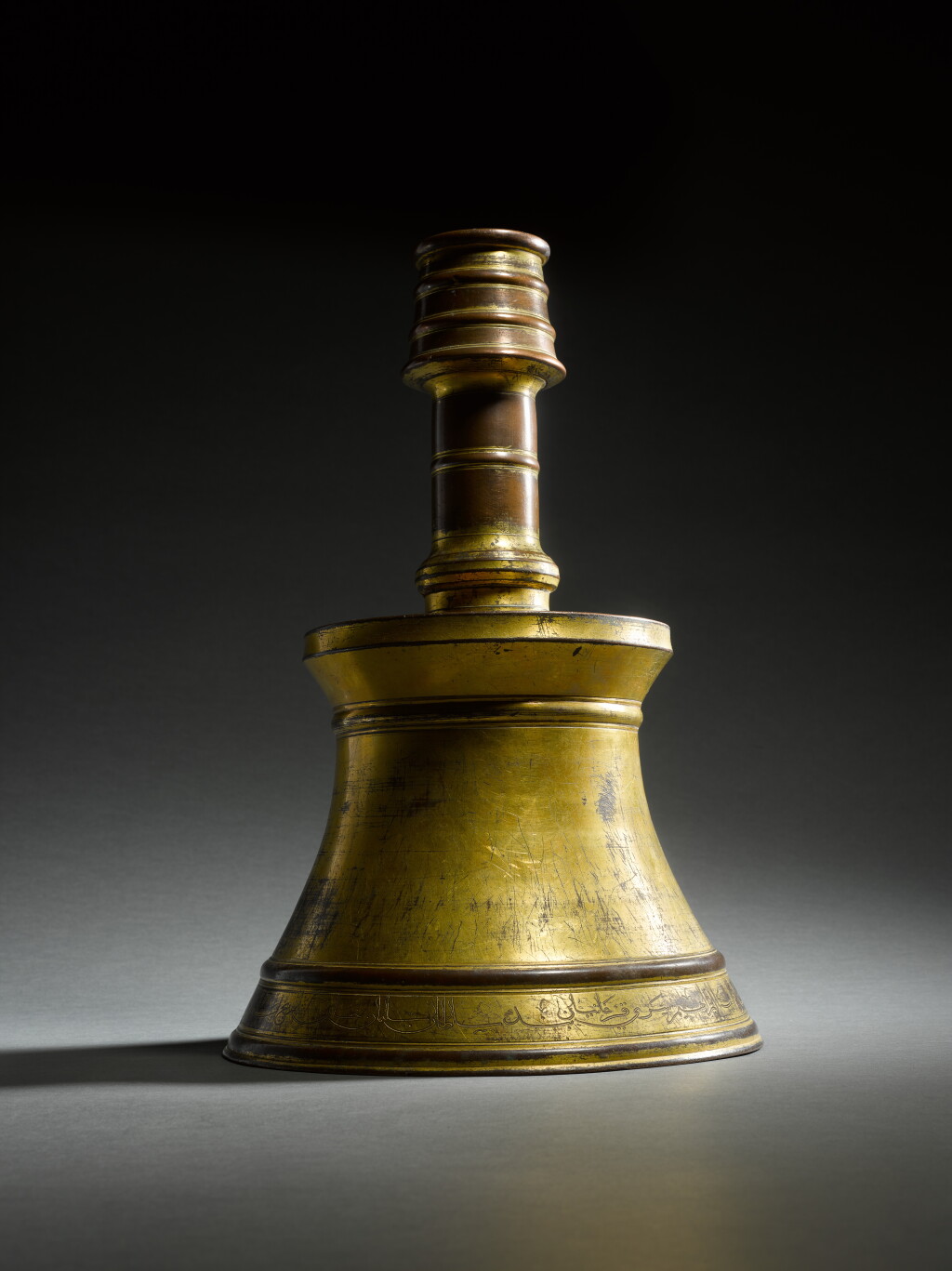 View full screen - View 1 of Lot 179. A large gilt-copper (tombak) candlestick, commissioned by a courtier of Suleyman the Magnificent, Turkey, Ottoman, dated Dhu'l-Hijja 945 AH/May 1539 AD.