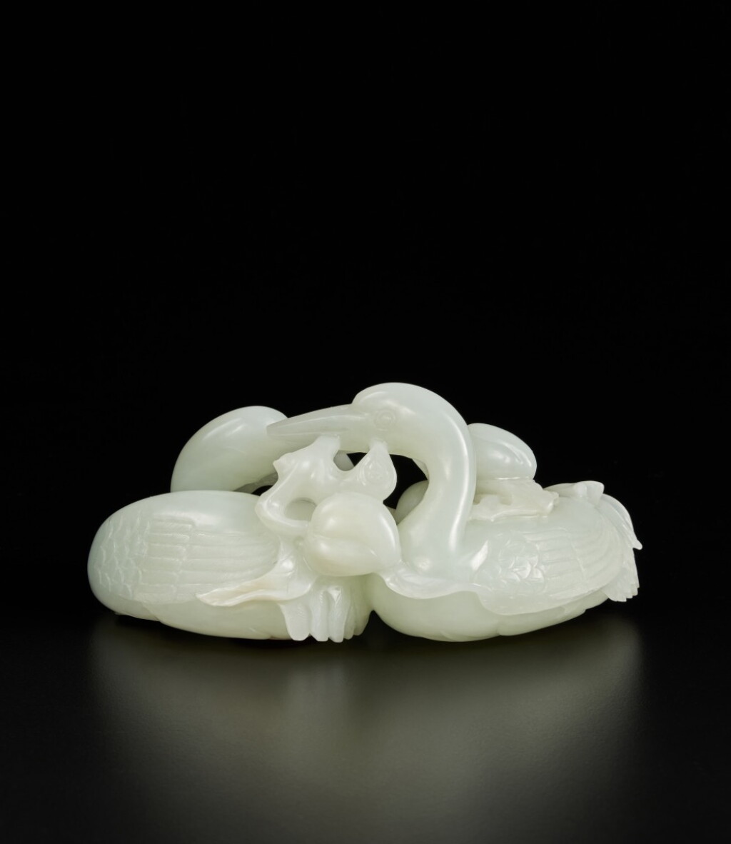 View full screen - View 1 of Lot 206. A white jade 'crane and peach' group, Qing dynasty, 18th / 19th century | 清十八 / 十九世紀 白玉雕瑞鶴銜桃把件.