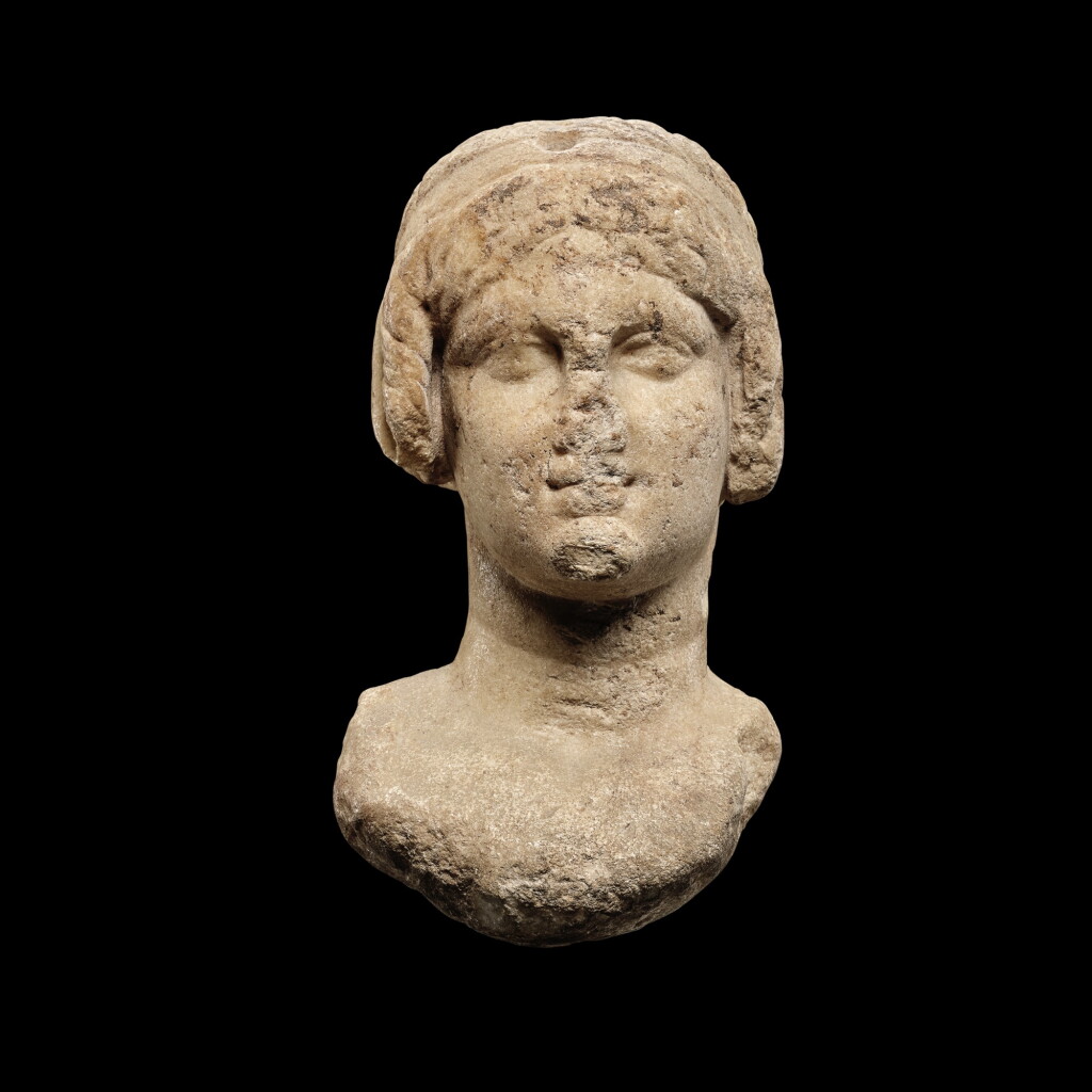 View full screen - View 1 of Lot 62. A Ptolemaic Marble Head of a Queen in the guise of Isis, circa 2nd Century B.C..