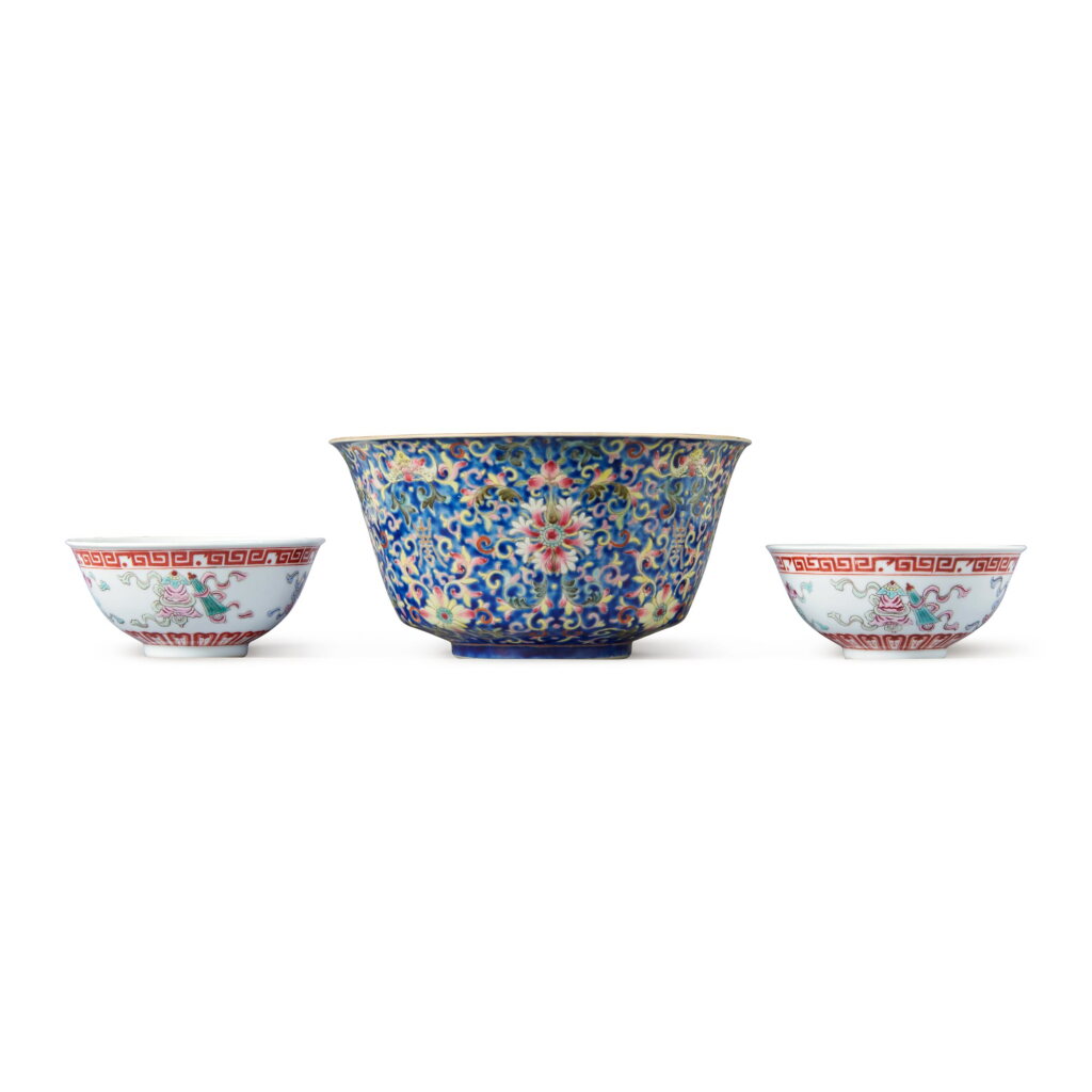 View full screen - View 1 of Lot 85. A blue-ground famille-rose 'lotus' bowl and a pair of famille-rose 'Eight Buddhist Emblems' bowls, Qing dynasty, 19th - 20th century | 清十九至二十世紀 藍地粉彩番蓮紋盌及粉彩八吉祥紋盌一對.