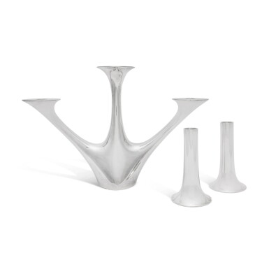 View full screen - View 1 of Lot 186. A Danish Silver Three-Light Candelabrum, No. 1075, Designed by Henning Koppel, and Pair of Candlesticks, No. 1139, Designed by Henning Koppel, Georg Jensen Silversmithy, Copenhagen, post-1945.