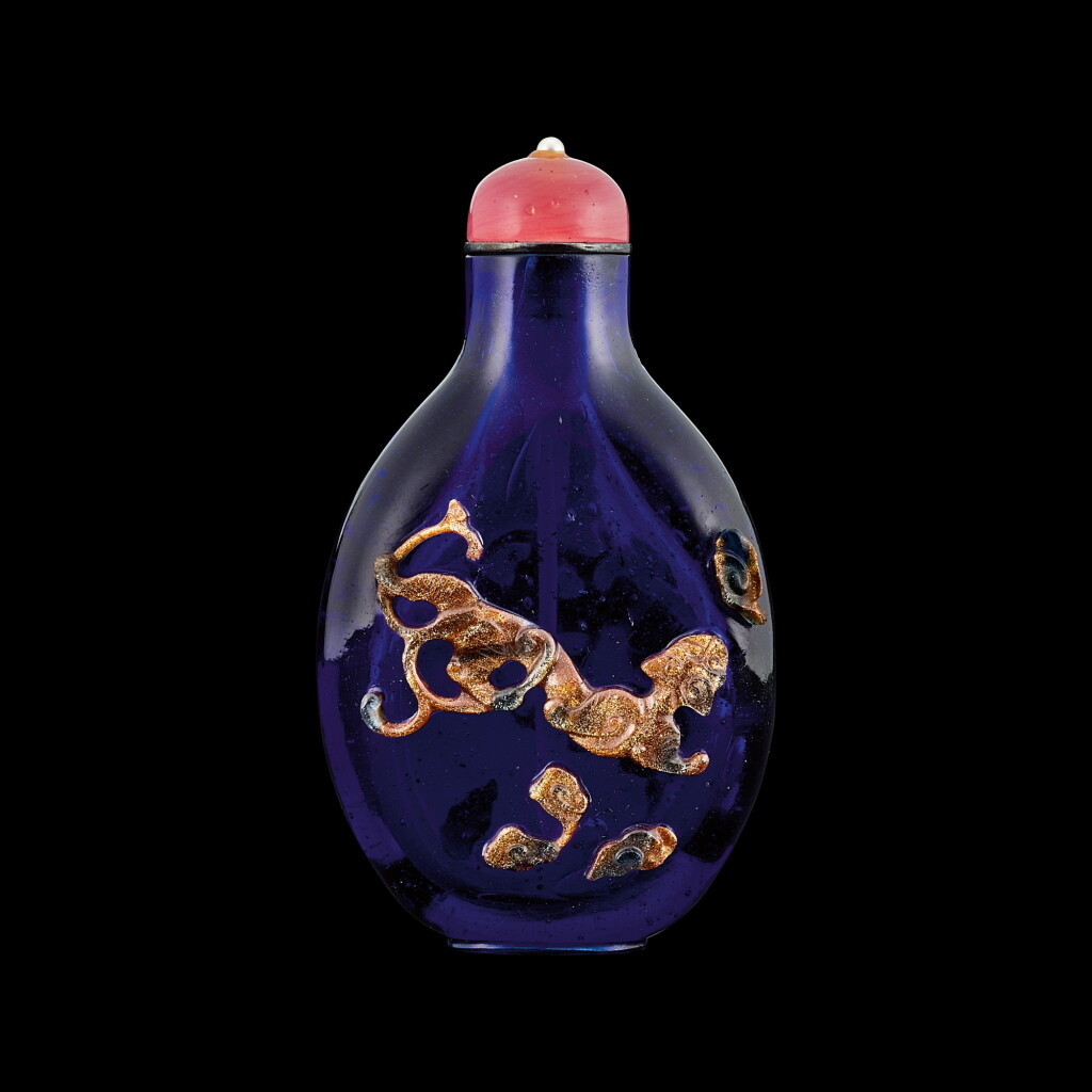 View full screen - View 1 of Lot 1019. An aventurine overlay purple-blue glass 'chilong' snuff bottle Qing dynasty, 18th century | 清十八世紀 透明紫地套金星玻璃螭龍紋鼻煙壺.