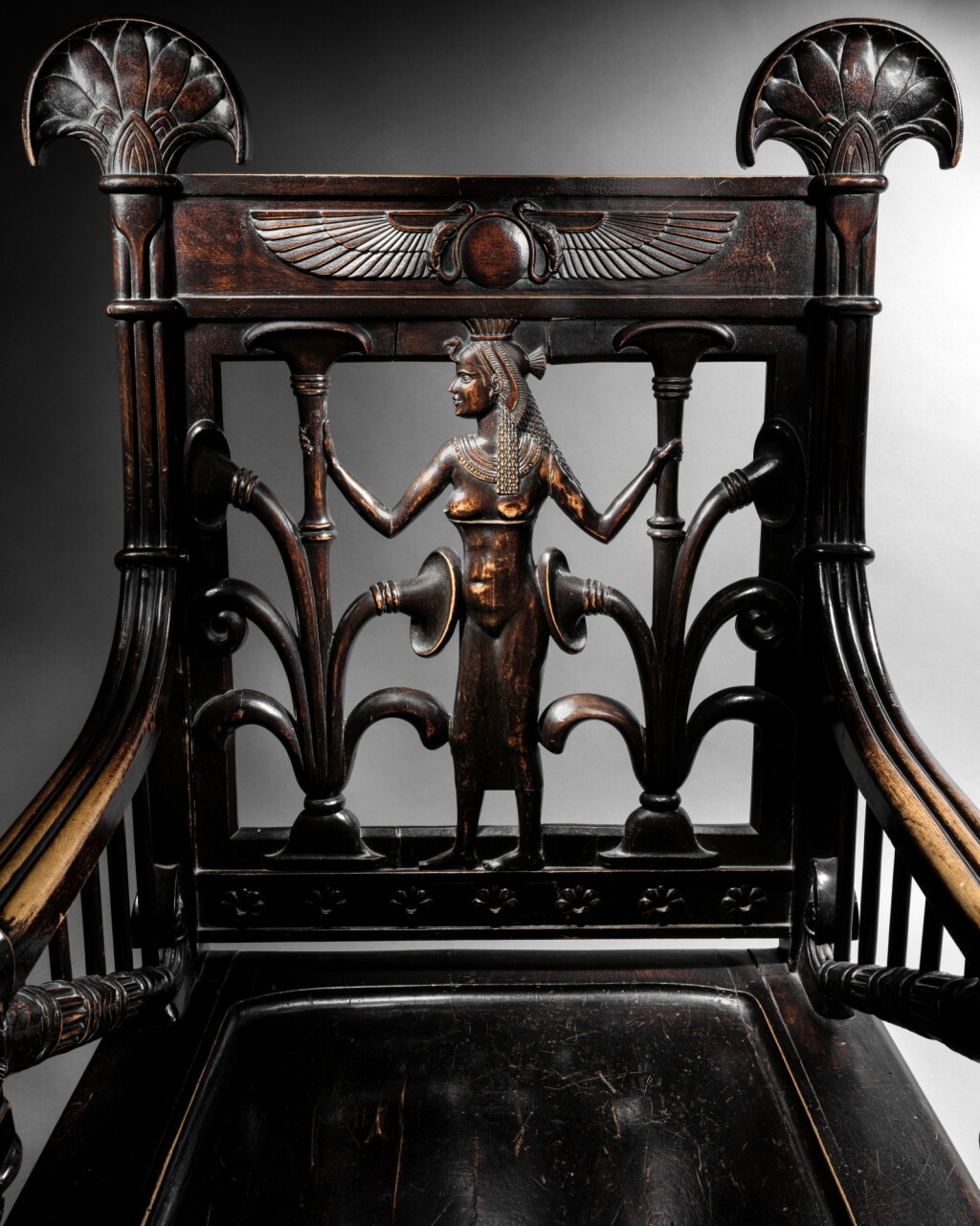 View full screen - View 1 of Lot 3. An Egyptianizing carved walnut ceremonial armchair, late 19th–early 20th century.