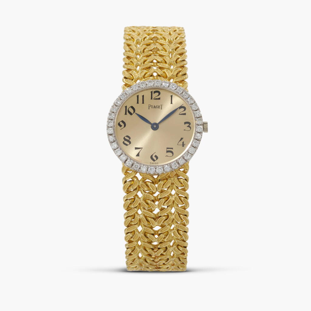 View full screen - View 1 of Lot 148. Reference 926 | A yellow gold and diamond set integrated bracelet watch | Circa 1964.