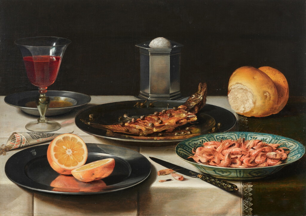 View full screen - View 1 of Lot 20. Breakfast still life of a baked fish garnished with capers and a sliced orange on pewter plates, shrimp in a Wanli Kraak porcelain dish, a silver salt, a knife, a claret glass, bread, and rolled pepper, on a draped table.