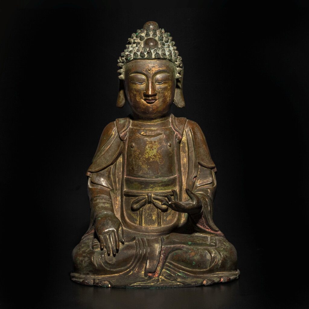 View full screen - View 1 of Lot 817. A parcel-gilt bronze seated figure of Buddha, Ming dynasty | 明 銅鎏金佛坐像.
