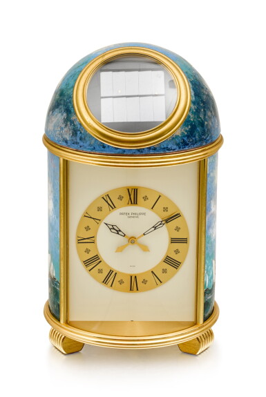 View full screen - View 1 of Lot 190. PATEK PHILIPPE | REFERENCE 1177M, A UNIQUE GILT BRASS SOLAR POWERED DOME TABLE CLOCK WITH CLOISONNÉ ENAMEL BY ELIZABETH PERUSSET LAGGER, MADE IN 1979.