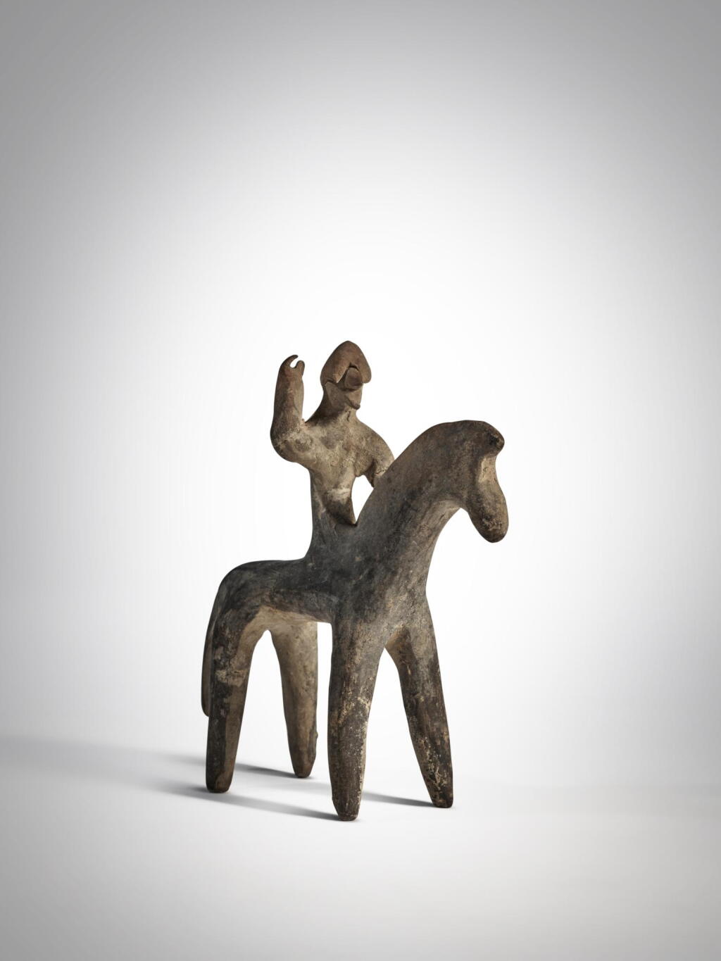 View full screen - View 1 of Lot 7. Greek Terracotta Figure of a Warrior on Horseback, Boeotia, circa Late 7th - Early 6th Century BC.