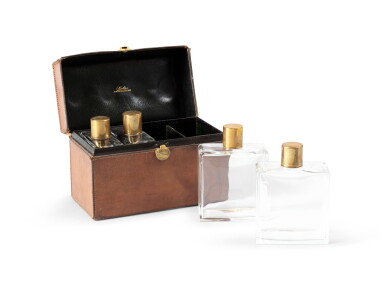 View full screen - View 1 of Lot 2108. Suite of four bottles in a brown leather case, circa 1930 | Suite de quatre flacons dans un étui en cuir brun, vers 1930.