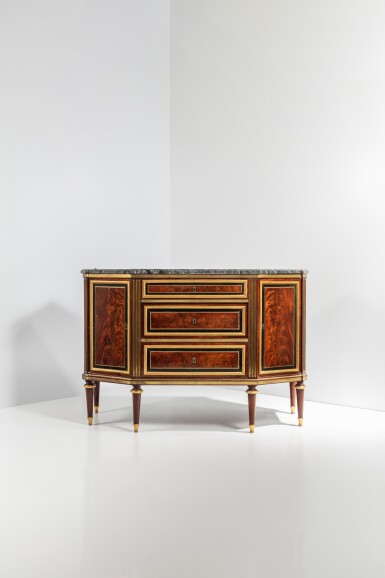 View full screen - View 1 of Lot 18. A Louis XVI gilt-bronze and gilt-brass mounted plum-pudding mahogany and stained pearwood commode à pans, circa 1785, attributed to Johann Gottlieb Frost.