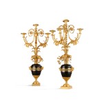 A pair of Louis XVI style patinated and gilt-bronze four-light candelabra, after a model by François Rémond, mid 19th century