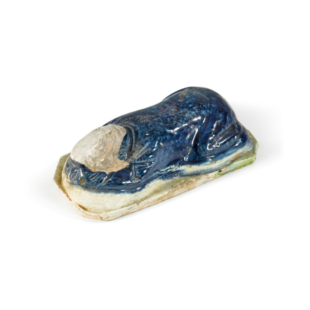 View full screen - View 1 of Lot 130. A blue-glazed pottery figure of a mourner, Tang dynasty | 唐 藍彩跪拜陶俑.