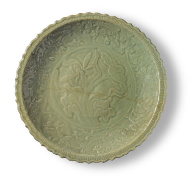 View full screen - View 1 of Lot 53. A rare and large carved 'Longquan' celadon-glazed 'lotus and wave' charger, Yuan - early Ming dynasty.