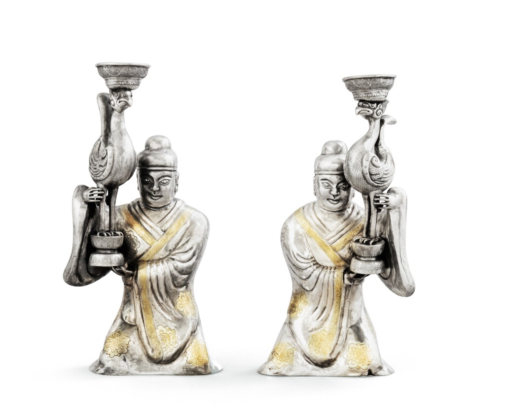 View full screen - View 1 of Lot 48. A pair of Chinese parcel-gilt silver candle-holder servants and phenix, 19th century | Paire de serviteurs et phénix porte-bougies en argent et vermeil, Chine, XIXe siècle.