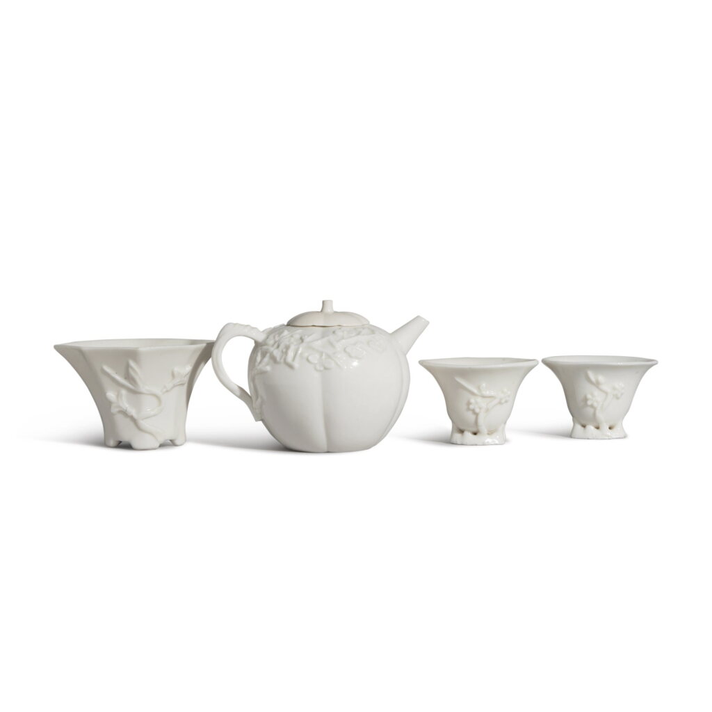 View full screen - View 1 of Lot 88. A group of three 'Dehua' cups and a 'Dehua' teapot and cover, Qing dynasty | 清 德化白瓷小杯一組三件及德化白瓷茶壺.